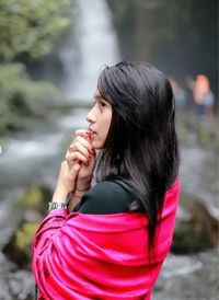 Side view of a young woman in water