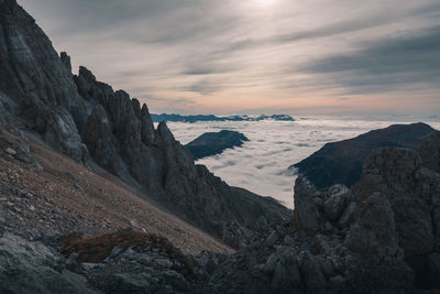 Scenic view of sea and mountains against sky