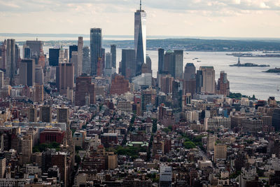 Aerial view of modern buildings in city against sky