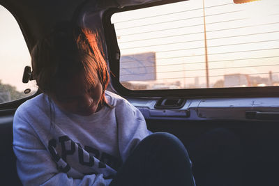 Thoughtful girl sitting in car