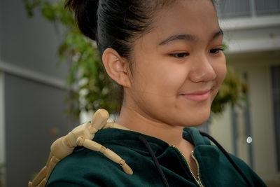 Close-up portrait of cute girl holding camera