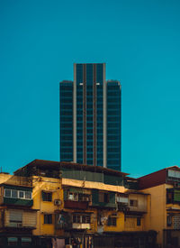 Low angle view of modern buildings against clear blue sky