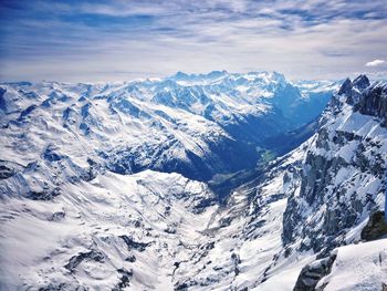 Scenic view of snowcapped mountains against sky