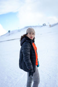 Full length of smiling girl standing in snow