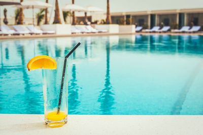 Close-up of drink by swimming pool