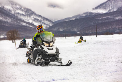 View of people riding bicycles on snow