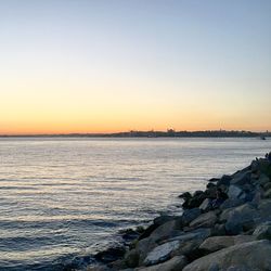 Scenic view of sea against clear sky during sunset