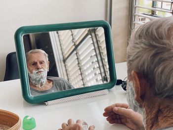 Portrait of man shaving 