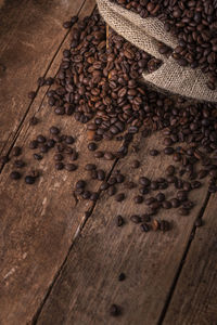 Close-up of roasted coffee beans on wooden table