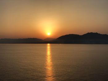 Scenic view of lake against sky during sunset