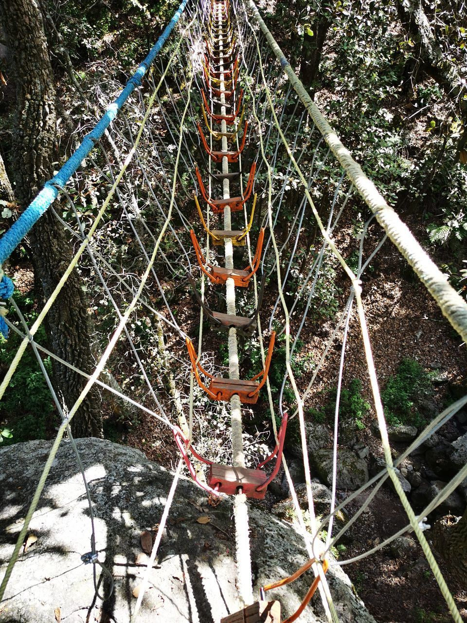 HIGH ANGLE VIEW OF CHAIN SWING RIDE IN PARK