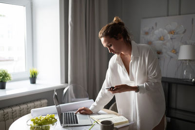 Female designer using devices at home