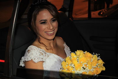 Close-up portrait of smiling young woman with flowers