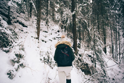 Man in snow covered forest