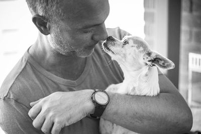 Man embracing dog