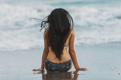 Rear view of woman at beach