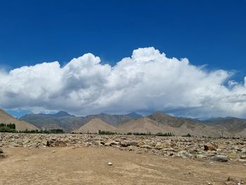 Scenic view of arid landscape against sky