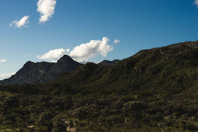 Low angle view of mountains against blue sky