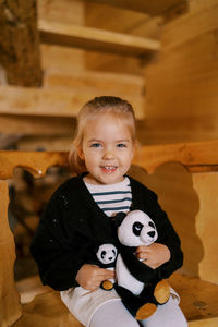 Portrait of cute girl playing with teddy bear