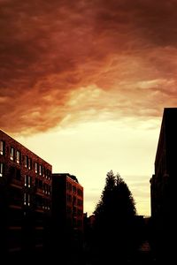 Low angle view of buildings against sky at sunset