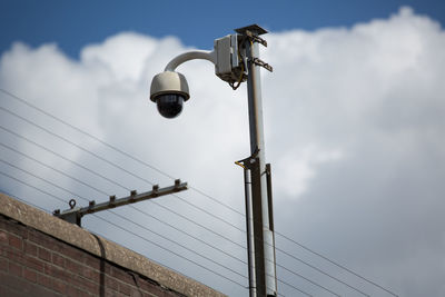 Low angle view of street light against sky