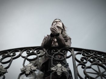 Low angle view of woman against clear sky