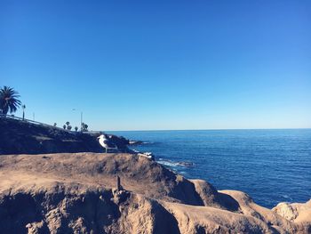 Scenic view of sea against clear blue sky