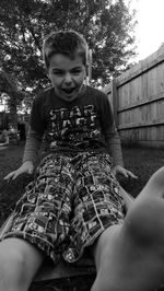 Happy boy sitting outdoors