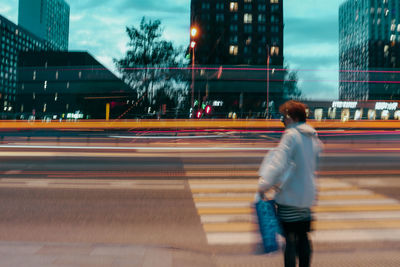 Rear view of man walking on city street