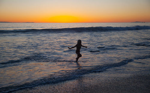 People on beach at sunset