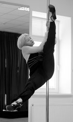 Woman practicing gymnastics at studio