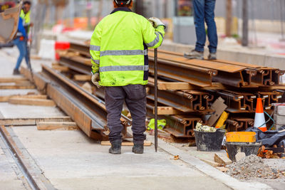 Rear view of men working at construction site