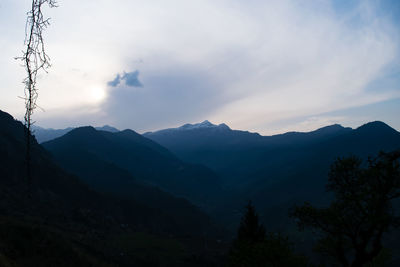 Scenic view of mountains against sky at dusk
