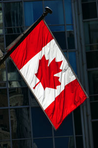 Low angle view of flag against buildings in city