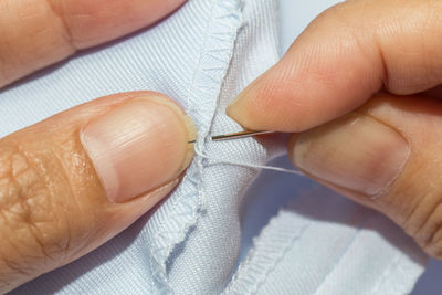 Midsection of tailor sewing textile