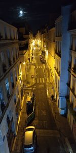 High angle view of city street amidst buildings at night