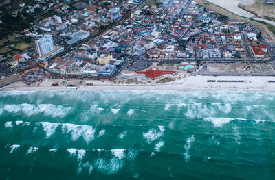 High angle view of swimming pool by building in city