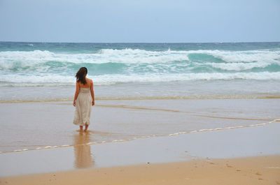 Rear view of woman at beach