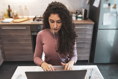 Young woman is working from home on the computer during restrictions due to the covid-19 pandemic