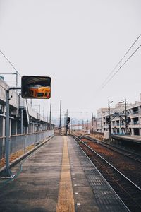 Railroad station platform against clear sky