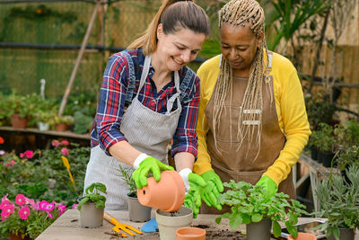 Happy women gardening together garden center