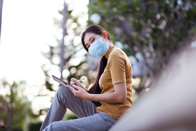 Young man using mobile phone outdoors