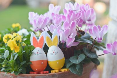 Close-up of toy rabbits on potted plants