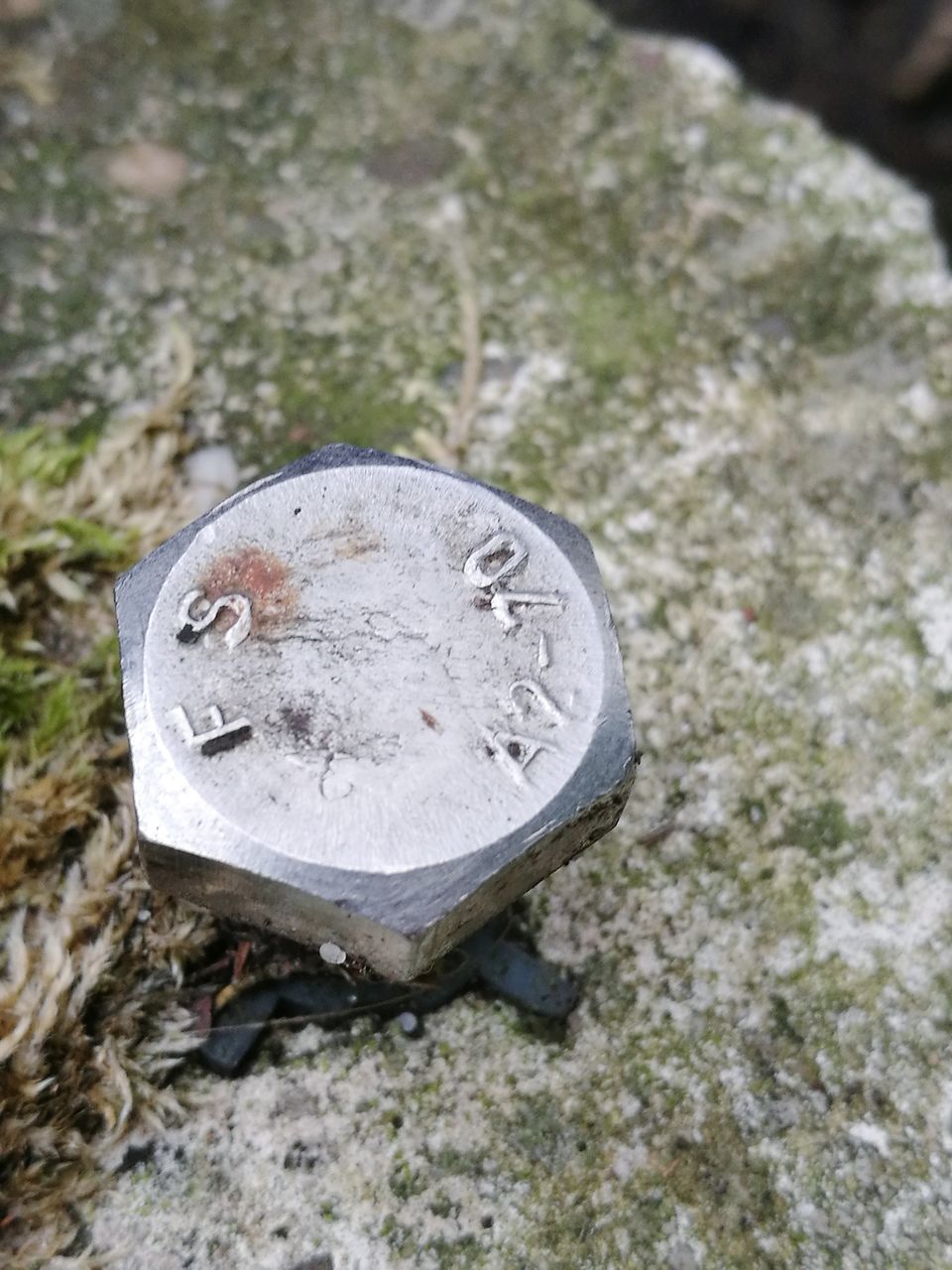 HIGH ANGLE VIEW OF OLD METAL ON ROCK