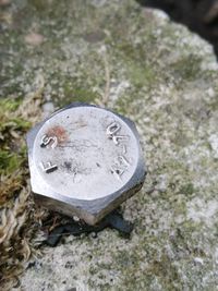 High angle view of old equipment on rock