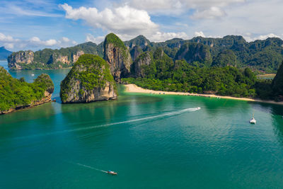Aerial view seascape phra nang cave beach with traditional long tail boat sailing on the sea at 