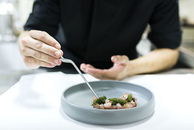 Midsection of man having food in restaurant