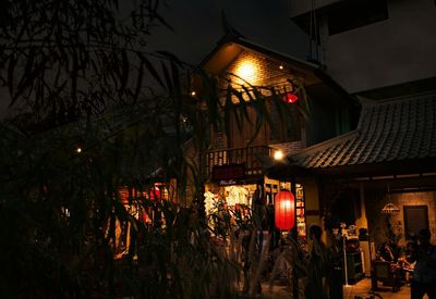 Illuminated lanterns hanging in city at night