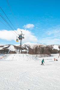 People skiing on snow covered landscape