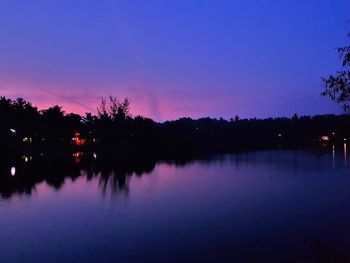 Scenic view of lake against sky at dusk